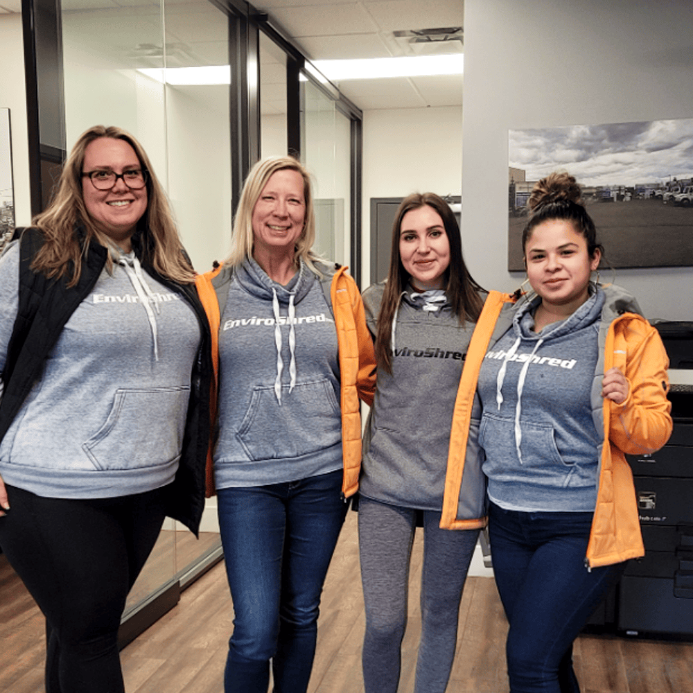 Group of women wearing sweaters with logo
