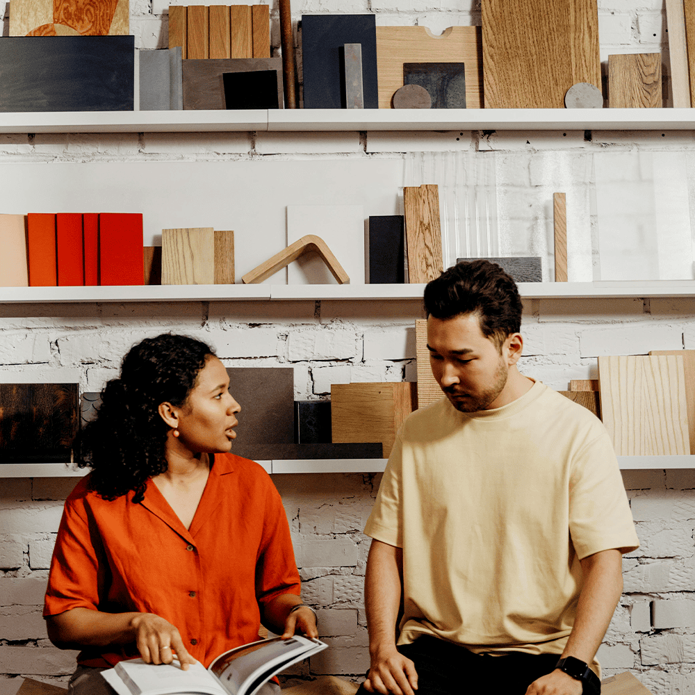 Two individuals looking at product