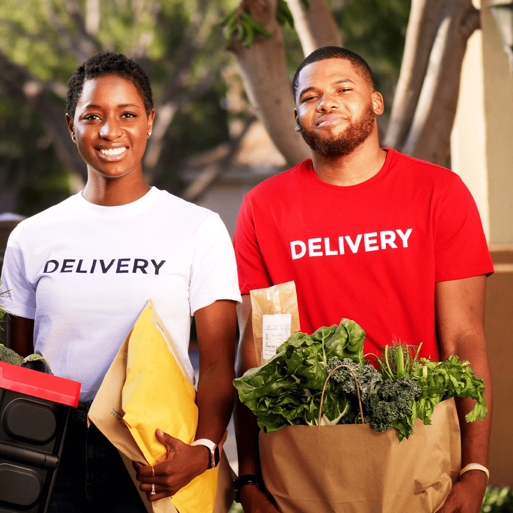 happy employees with logoed shirts carrying produce